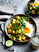 Potato and pea curry from Sri Lanka with fried eggs
