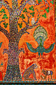 Laos, Luang Prabang. Mosaic depicting a tree, peacock, and other animals.
