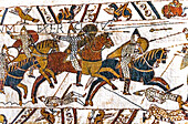 Colorful Medieval Bayeux tapestry, Bayeux, Normandy, France. Created 11th century right after Battle of Hastings 1066 AD showing Norman Conquest. Shows Norman calvary battle and deaths in lower panel