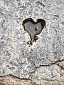 Italy, Tuscany, Chiusure. A carving of a heart in a stone walkway.