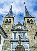 Fassade der Kirche St. Leodegar, Luzern, Schweiz. St. Michael-Statue Ursprünglich ein Kloster aus den 1100er Jahren, wurde es 1874 zu einer Kirche.