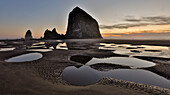 USA, Oregon. Cannon Beach with Haystack near sunset and low tide.
