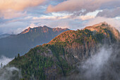 Misty clouds swirling around peaks of the North Cascades in Heather Meadows Recreation Area, Washington State