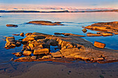 Canada, Ontario, Rossport. Rocky shoreline of Lake Superior at sunrise.