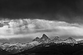 USA, Idaho. Black and White landscape of Virga clouds and view of Teton Mountains from the west.
