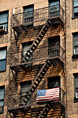 American Flag Outside An Apartments Building In Chelsea, Manhattan, New York, Usa