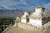 Chortens on a hill overlooking the Indus Valley and Leh. Leh was the capital of the Himalayan kingdom of Ladakh, now the Leh District in the state of Jammu and Kashmir, India. Leh is at an altitude of 3,500 meters (11,483 ft).