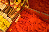 Close-up of red tika powder and other offerings used to worship Shiva, stall in bazaar, holy city of Omkareshwar, Madhya Pradesh, India, Omkareshwar, Madhya Pradesh, India.