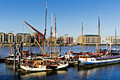 United Kingdom, Bermondsey; London, Barge and sailing boats on Thames river