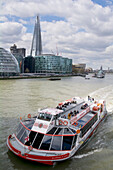 United Kingdom, London, The Shard building in background, Cruise ship on Thames river
