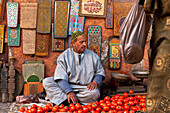 Morocco, Man selling tomatoes at souk; Marrakech