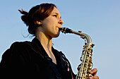 United Kingdom, England, Girl playing saxophone; Esher