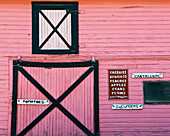 USA, Colorado, Pink barn farm store selling fresh local fruit and vegetables; Palisade