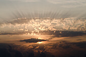 Italy, Marche, Sun rays through clouds at sunrise; Porto San Giorgio