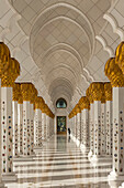 Looking Along Corridor Of Columns Surrounding The Courtyard Of The Sheikh Zayed Grand Mosque,Abu Dhabi, United Arab Emirates