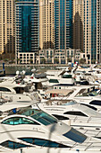 UAE, Dubai, Boats and residential flats; Dubai Marina