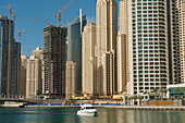 Dubai, Uaeboat In Dubai Marina In Front Of Large Residential Blocks Of Flats