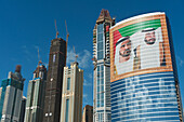 UAE, Large portrait of Sheikh Mohammed Bin Rashid Al Maktoum and Khalifa bin Zayed Al Nahyan on office building; Dubai