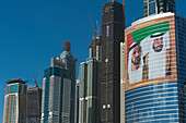 UAE, Large portrait of Sheikh Mohammed Bin Rashid Al Maktoum and Khalifa bin Zayed Al Nahyan on office building; Dubai