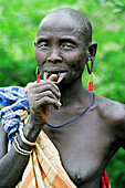 Portrait of a Mursi tribal woman with her lower lip pierced to hold a traditional 'debhi a tugoin' (lip plate). Makki / South Omo / Southern Nations, Nationalities & People's Region (Ethiopia).