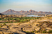 A dam lake and the changing landscape of the desert and the Aravali Hills in the Pali Plain of Rajasthan; Rajasthan, India