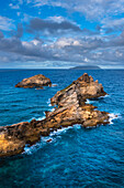 Vibrant Caribbean Sea surrounding the rock formations on the Pointe des Chateaux peninsula on Grande-Terre; Guadeloupe, French West Indies
