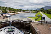 A small ship pulls into the Caledonian Canal, Scotland; Inverness, Scotland