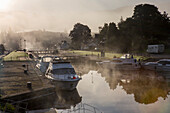 As the sun rises, fog lifts along the Caledonian Canal at Fort Augustus, Scotland; Fort Augustus, Scotland