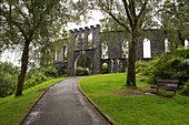 Trees frame McCaig's Tower on Battery Hill in Oban, Scotland; Oban, Argyll, Scotland