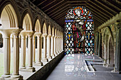Double exposure image of stained glass and cloisters inside the Benedictine Abbey on Iona, Scotland; Iona, Scotland