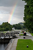 A rainbow stretches across the sky over Neptune's Staircase along the Caledonian Canal near Corpach, Scotland; Corpach, Scotland