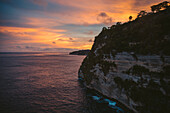 Sunset over ocean with sea cliffs at Diamond Beach, Nusa Penida, Bali, Indonesia; Nusa Penida, Bali, Indonesia