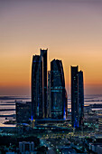View of the silhouetted highrise towers along the Persian Gulf coast at sunset (HDR); Abu Dhabi, United Arab Emirates