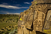 Pueblo Indian petroglyphs overlooking a desert landscape.