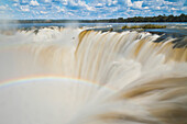 A rainbow over Devil's Throat Overlook at Iguazu Falls.