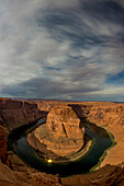 Storm clouds above Horseshoe Bend in the Colorado River at night.