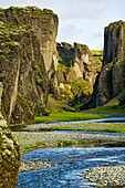 A river flowing through a gorge of volcanic rock in southern Iceland.; Fjadrargljufur gorge, near Kirkjubaejarklaustur, Iceland.