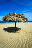 A beach umbrella on Vichayito Beach, nr Mancora, northern Peru.; Vichayito Beach, near Mancora, on the Pacific coast of northern Peru.
