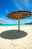 A tropical beach scene in the Caribbean.; Canouan Island, the Grenadines, St Vincent and the Grenadines, in the Caribbean.