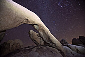 Arch Rock under a starry night sky in Joshua National Park; Joshua Tree National Park, California, United States of America