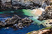 A paddleboarder in a secluded bay.