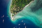View from directly above of boats moored in the water off Batu Bolong Beach in Komodo National Park; Canggu, Bali, Indonesia