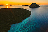 Aerial view of the silhouetted islands of Komodo National Park, home of the famous Komodo Dragon at sunset; Lesser Sunda Islands, Indonesia