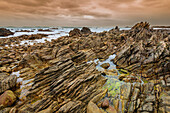 Jagged rock formations on the rocky shore at Cape Agulhas in Agulhas National Park; Western Cape, South Africa