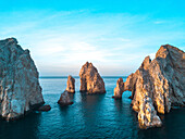 Dramatic rock formations and Arcos de Cabo San Lucas (Arch of Cabo San Lucas) on the coast at Lands End at sunset; Cabo San Lucas, Baja California Sur, Mexico