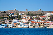 Traditional buildings along the waterfront in the harbor at Emborio, the main town on Halki (Chalki) Island; Dodecanese Island Group, Greece