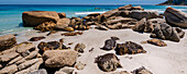 Large boulders and sandy beach at Clifton Beach on the Atlantic Ocean in Cape Town; Cape Town, Western Cape, South Africa
