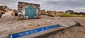 Sign and metal plaque indicating the Southern Most Point of the Continent of Africa and the maritime border of the Indian and Atlantic Oceans at Cape Agulhas; Western Cape, South Africa