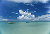 Clouds and boats, Aruba.; ARUBA ISLAND, NETHERLANDS ANTILLES, WEST INDIES.