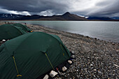 View looking over the three green tents at base camp on the shore of lake Centrum S??.; Northeast Greenland , Greenland